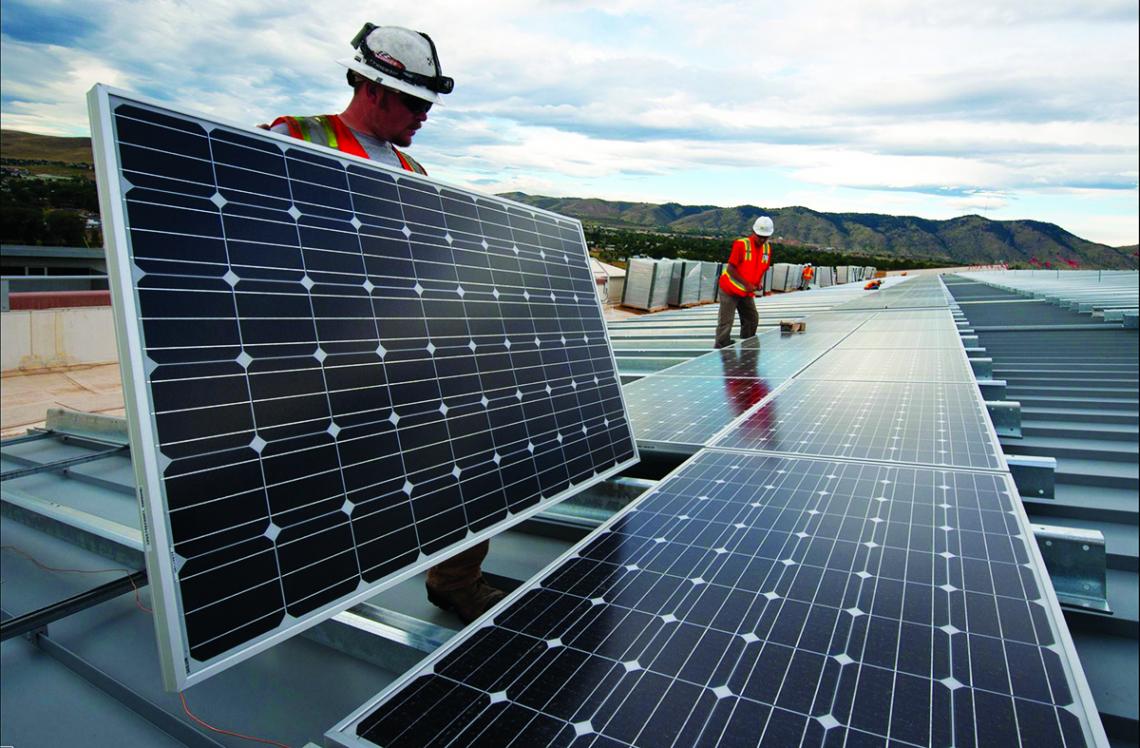 Workers install solar panels to capture renewable energy. Workers install solar panels to capture renewable energy.